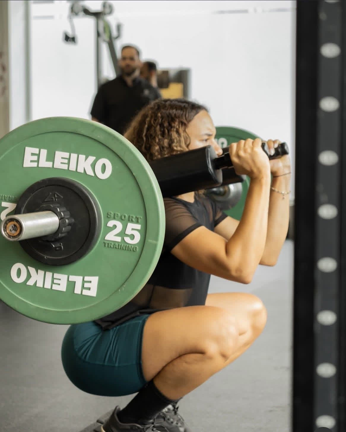 Atleta ejecutando un front squat con barra en rack